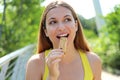 Fitness woman eating an energy bar. Close up of sporty girl resting while biting a muesli bar. Pretty athletic young woman eating Royalty Free Stock Photo