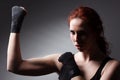 Fitness woman exercise stretch arms boxing weight punch in Dark background, studio lighting gradient gray top light Royalty Free Stock Photo