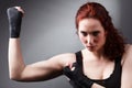 Fitness woman exercise stretch arms boxing weight punch in Dark background, studio lighting gradient gray top light Royalty Free Stock Photo