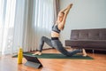 Fitness woman exercising on the floor at home and watching fitness videos in a tablet. People do sports online because Royalty Free Stock Photo