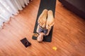 Fitness woman exercising on the floor at home and watching fitness videos in a tablet. People do sports online because Royalty Free Stock Photo