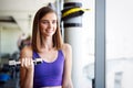Fitness woman. Fit fitness girl smiling happy lifting weights looking strength training muscles. Royalty Free Stock Photo