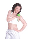 Fitness woman giving you an green apple and smiling on white isolated Royalty Free Stock Photo