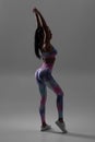 Fitness woman on the gray background. Athletic girl, butt in leggings