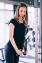 Fitness woman in the gym. Young woman doing fitness exercises in the gym, with lot machine