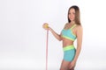 Fitness woman holding an apple and measuring tape Royalty Free Stock Photo