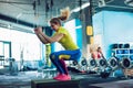 Fitness woman jumping on box training at the gym, girl in leggins and a t-shirt Royalty Free Stock Photo