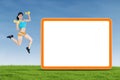 Fitness woman jumping with empty board Royalty Free Stock Photo