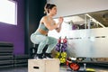 Caucasian female doing box jump workout at gym. Royalty Free Stock Photo