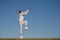 Fitness woman jumping outdoor. Adult woman in sportswear exercising in morning