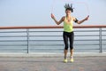 Fitness woman jumping rope at seaside Royalty Free Stock Photo