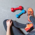 Fitness woman legs with colorful dumbbells top view Royalty Free Stock Photo