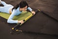 Fitness woman lies on the gym floor and does exercises with trx rip trainer. Royalty Free Stock Photo