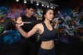Fitness woman lifting weight, Sport, bodybuilding, lifestyle and people concept - Young man and woman with barbell flexing muscles