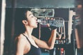 Fitness woman in loft gym drinking water After a good workout