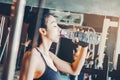 Fitness woman in loft gym drinking water After a good workout