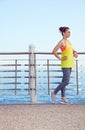 Fitness woman looking into distance and listening to the music Royalty Free Stock Photo