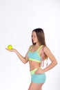 Fitness woman looks at apple Royalty Free Stock Photo