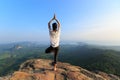 Fitness woman meditating on mountain peak Royalty Free Stock Photo