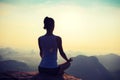 Fitness woman meditating on sunrise mountain peak Royalty Free Stock Photo