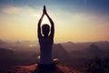 Fitness woman meditating on sunrise mountain peak Royalty Free Stock Photo