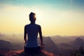 Fitness woman meditating on sunrise mountain peak Royalty Free Stock Photo