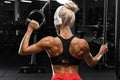 Fitness woman with muscular back in gym. Athletic girl working out