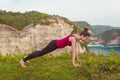 Fitness woman doing yoga exercises. Girl training plank pose. Royalty Free Stock Photo