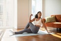 fitness woman practicing yoga doing seated spinal twists indoor