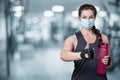 Fitness woman protective mask showing hand good