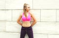 Fitness woman ready to workout in city, female athlete standing in profile, sport and healthy lifestyle