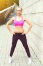 Fitness woman ready to workout in city, female athlete standing, sport and healthy lifestyle