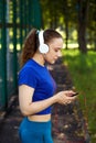 Fitness woman resting after intense physical training listerning to music