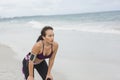 Fitness Woman resting after work out on the beach at cloudy winter day Royalty Free Stock Photo