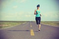 Fitness woman runner running on road