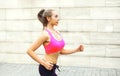 Fitness woman running in city, female runner workout - sport and healthy lifestyle concept