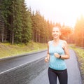 Fitness woman running at the morning in mountains. Royalty Free Stock Photo