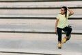 Fitness woman sitting on stairs and enjoying sunbeams. Royalty Free Stock Photo