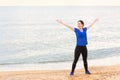 Fitness woman in sporstwear on the beach