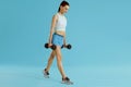 Fitness woman in sport wear exercising with gym weight at studio Royalty Free Stock Photo