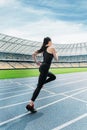 Fitness woman in sportswear running on running track stadium