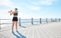 Fitness, woman and stretching arms at the beach for running, exercise or cardio workout outdoors. Active female runner Royalty Free Stock Photo