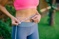 Fitness Woman With Tape Measure Showing Her Waist, close up Royalty Free Stock Photo