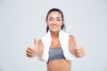 Fitness woman with towel showing thumbs up Royalty Free Stock Photo