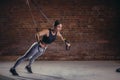 Fitness woman workout on TRX straps in gym. Crossfit style. Training TRX. Royalty Free Stock Photo