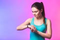 Fitness woman using fitness tracker on wrist over white background. A woman using a smartwatch. Healthy lifestyle. Copy space Royalty Free Stock Photo