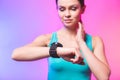 Fitness woman using fitness tracker on wrist over white background. A woman using a smartwatch. Healthy lifestyle. Copy space Royalty Free Stock Photo
