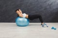 Fitness woman working on her abs with fitness ball indoors Royalty Free Stock Photo