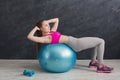 Fitness woman working on her abs with fitness ball indoors Royalty Free Stock Photo