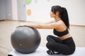 Fitness woman. Young attractive woman doing push ups using ball Royalty Free Stock Photo